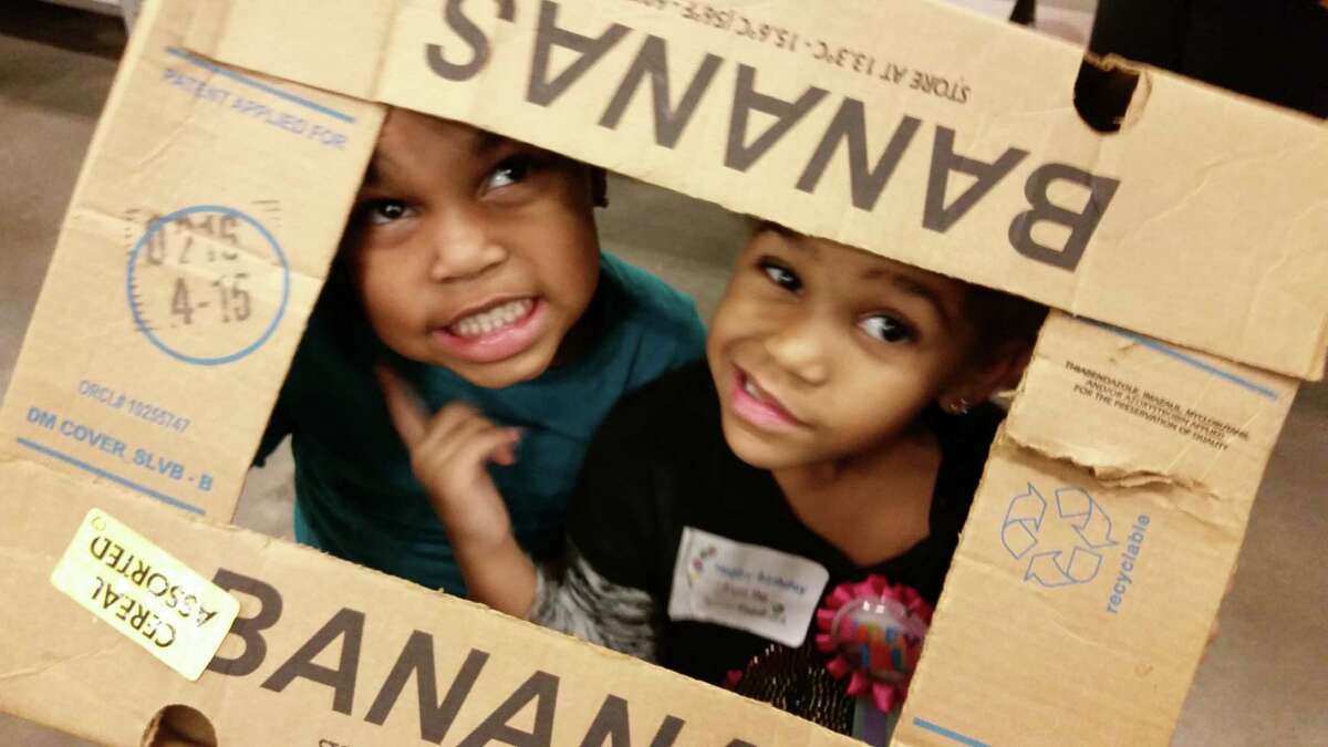 Eden Bashir poses with a friend at the Houston Food Bank for the girls' joint birthday celebration.