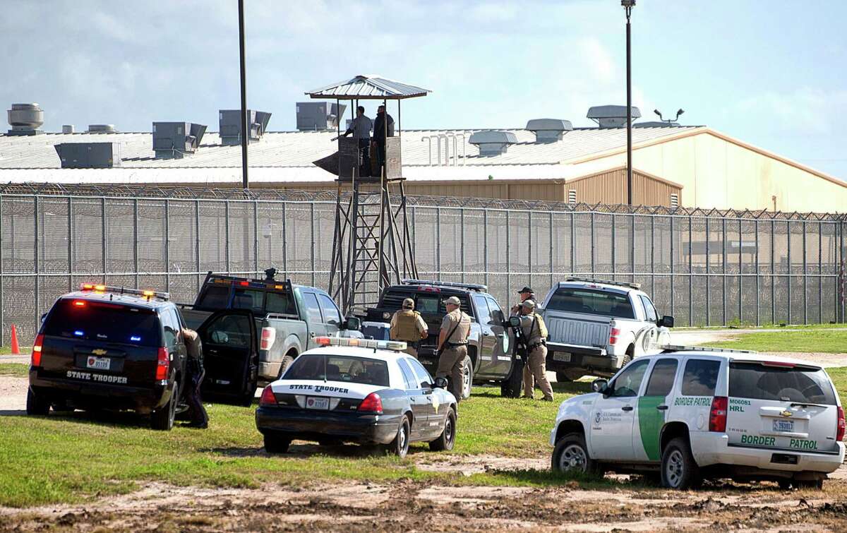 Law enforcement officials from a wide variety of agencies converge on the Willacy County Correctional Center in Raymondville, Texas on Friday, Feb. 20, 2015 in response to a prisoner uprising at the private immigration detention center. A statement from prison owner Management and Training Corp. said several inmates refused to participate in regular work duties early Friday. Inmates told center officials of their dissatisfaction with medical services. (AP Photo/Valley Morning Star, David Pike)