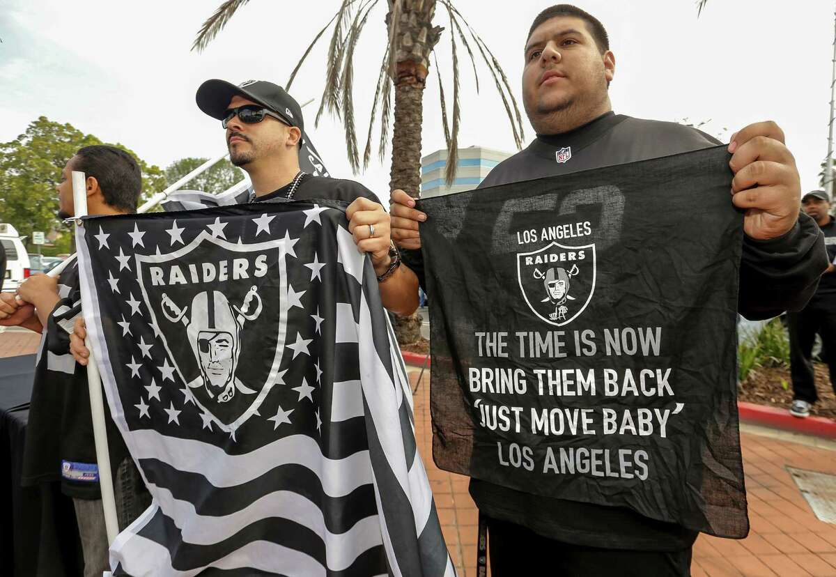 Raiders fans attend a news conference for a proposed NFL football stadium by the owners of the San Diego Chargers and Oakland Raiders in Carson, Calif.