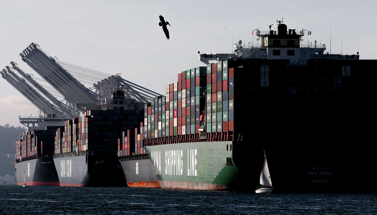 Cargo ships filled with containers are lined up along the docks at the Port of Oakland in February, after the International Longshore and Warehouse Union reached a tentative agreement on a new five-year contract.