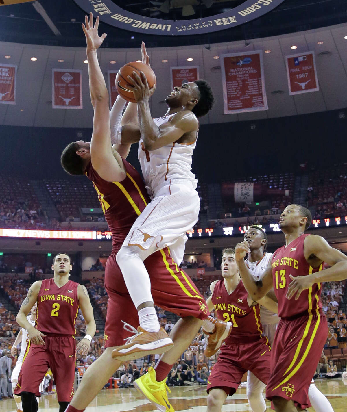 Texas' Isaiah Taylor, right, goes through Iowa State's Georges Niang on his way to a basket in the second half Saturday in Austin. Taylor scored 23 points in the Longhorns' loss, their sixth in the last nine games.