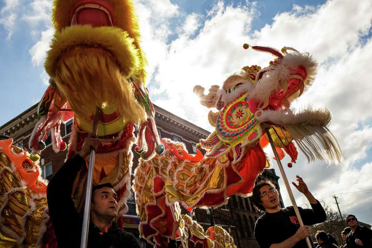 Hoisting ornate lion figurines, Mak Fai Kung Fu Club members approach Hing Hay Park to ring in the Year of the Sheep during the annual Lunar New Year Celebration Saturday, February 21, 2015, within Chinatown in Seattle, Washington. The day-long celebration includes traditional dragon and lion dances, Japanese Taiko Drumming, martial arts, delicious foods and crafting.
