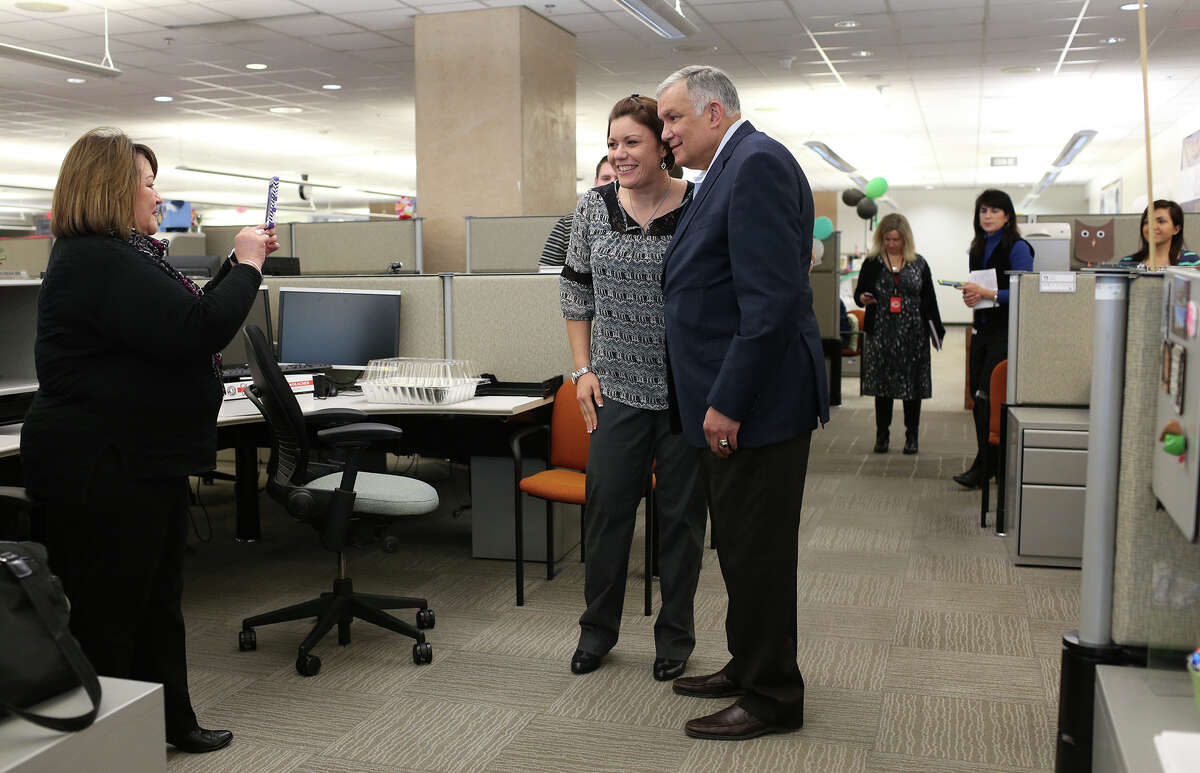 Stefanie Wrenn gets her picture taken with USAA CEO and President Joe Robles by Fina Spindler during a surprise visit Wednesday.