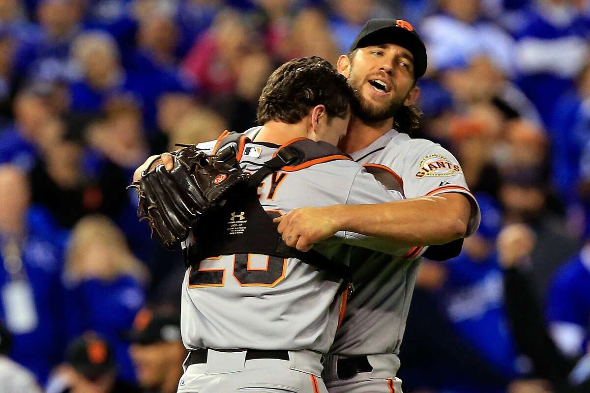 Buster Posey and Madison Bumgarner of the San Francisco Giants celebrate after defeating the Kansas City Royals to win Game Seven of the 2014 World Series by a score of 3-2 at Kauffman Stadium on October 29, 2014 in Kansas City, Missouri.