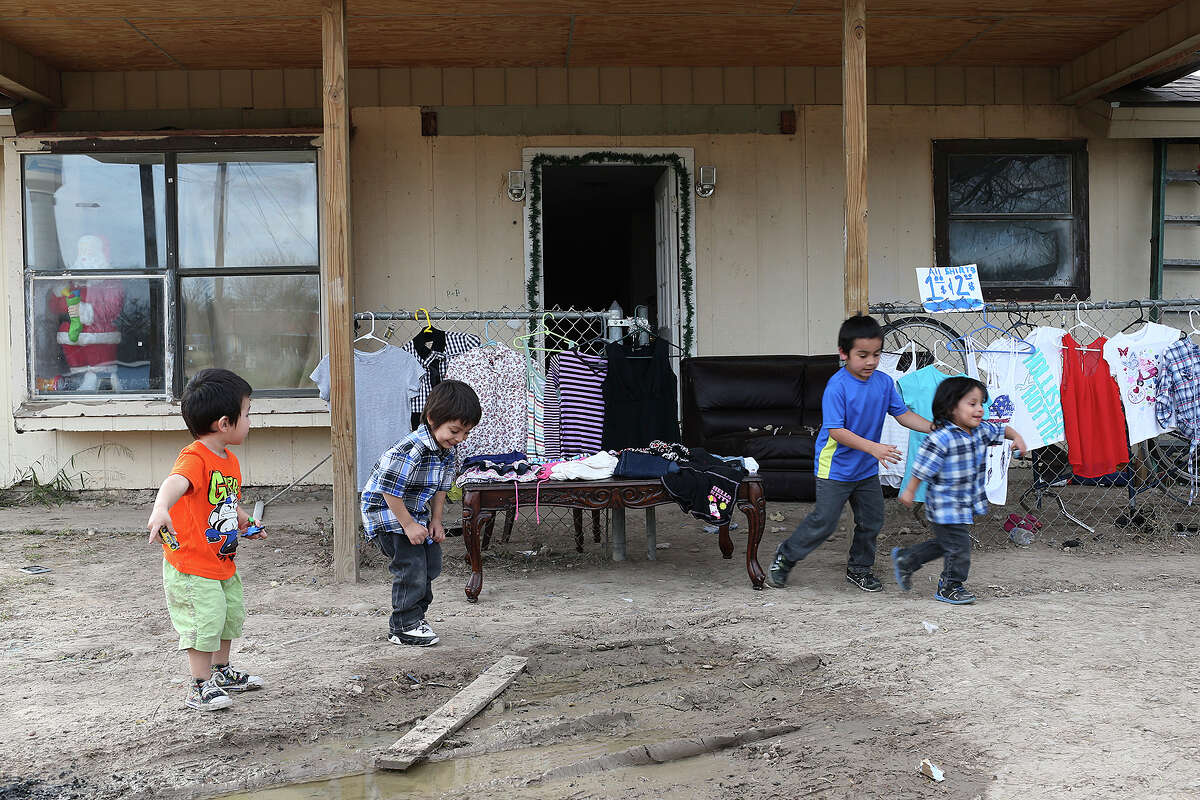 From left, Jesus Javier Gonzalez, 2, Josiah Galvan, 3, Mario Galvan, 6 and Joseph Galvan, 2, play outside their home on Lago Vista Drive in Maverick County, Monday, Jan. 26, 2015. More than $70,000 was paid to a contractor to provide sidewalks along Lago Vista Drive but the work was never done. Two years ago, FBI arrested three Maverick County Commissioners and a dozen other people, including county worker, on corruption and other charges. County commissioners and other public officials handed out $18 million in contracts as part of a Texas Department of Transportation grant to improve roadways and drainage in colonias, poor, unincorporated neighborhoods that suffer from a lack of services. On some occasions, commissioners handed out inflated contracts and the contractors kicked back a portion of the profits. Other times, contractors were paid in full without conducting any work.