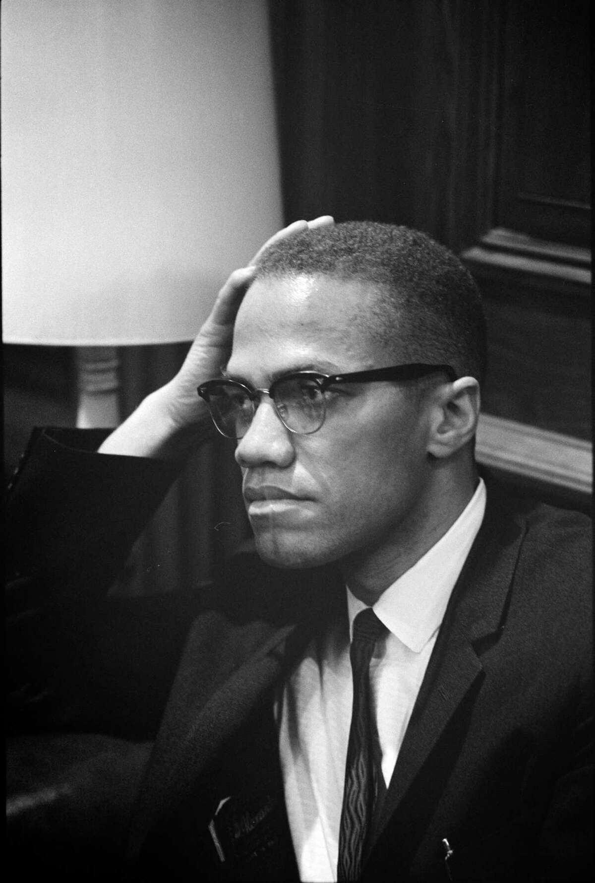 Malcolm X listens as Martin Luther King Jr. talks to reporters on March 26, 1964. They met only once, a grip-and-grin for cameras as they passed in a Capitol Hill hallway after observing a filibuster over the proposed Civil Rights Act. Over time, MalcolmÂ?’s respect for King increased. Illustrates MALCOLMX (category l), by Krissah Thompson Â 2015, The Washington Post. Moved Friday, Feb. 20, 2015. (MUST CREDIT: By Marion S. Trikosko, U.S. News & World Report Magazine Photograph Collection/ Library of Congress Prints and Photographs Division)
