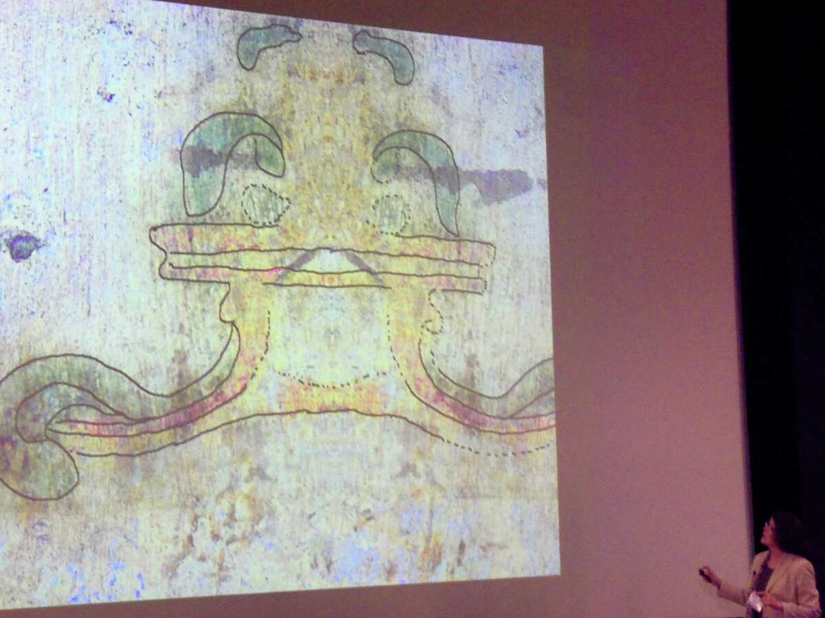 Trinity University chemistry professor Michelle Bushey shows a postulated image of how a mission-era fresco in the Alamo might have looked during the history symposium held by Texas A&M University's Center for Heritage Conservation.