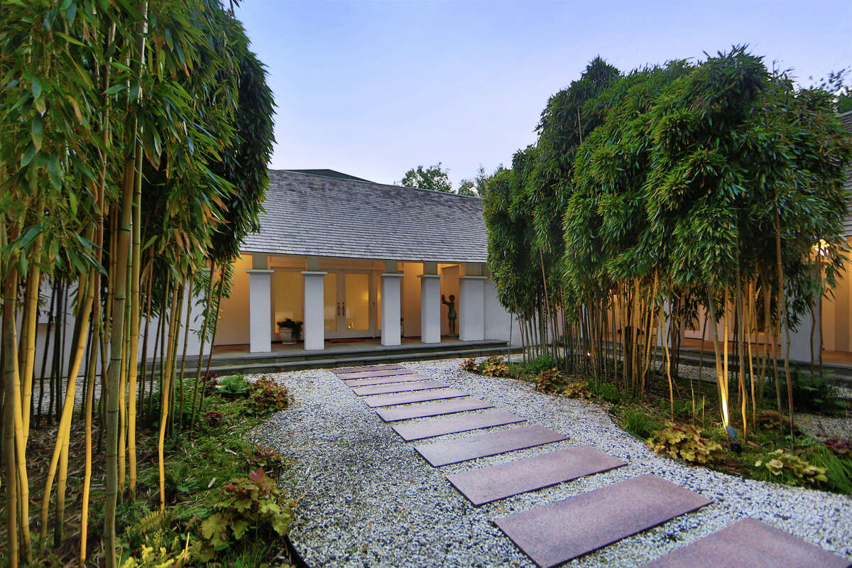 The front courtyard and entrance to the house with bamboo gardens on either side.