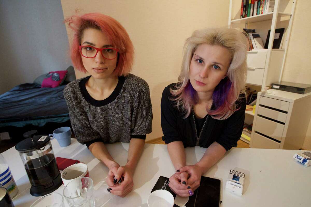 Two members of the punk provocateur band Pussy Riot Maria Alekhina, right, and Nadezhda Tolokonnikova pose for a photo, during an interview with The Associated Press, in Moscow, Russia, Thursday, Feb. 19, 2015. Two members of the punk provocateur band Pussy Riot have released a new music video dedicated to Eric Garner, an unarmed man who was killed when a New York City police officer put him in a fatal chokehold. In the video the are dressed in Russian riot police uniforms and shown buried alive. The song is titled "I Can't Breathe," the last words of Eric Garner captured on video by a bystander.