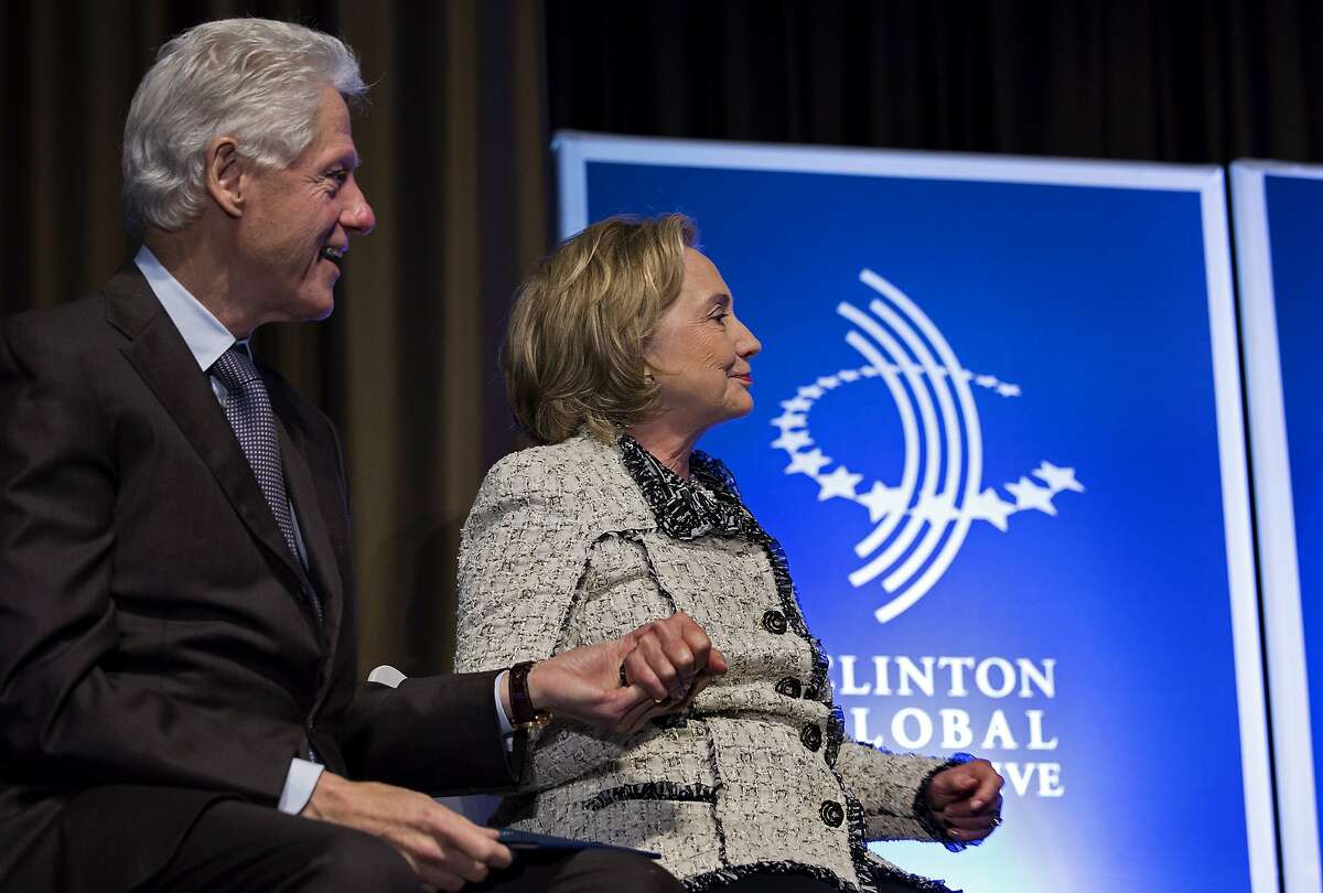 Former President Bill Clinton and former Secretary of State Hillary Clinton holds hands after she introduced Rio de Janiero Mayor Eduardo Paes at the Clinton Global Initiative (CGI) Mid-Year Meeting Monday, May 6, 2013 in New York. Details for CGI Latin America and a new commitment from the C40 Climate Leadership Group in partnership with the Clinton Foundation were announced at the event. (AP Photo/Craig Ruttle)