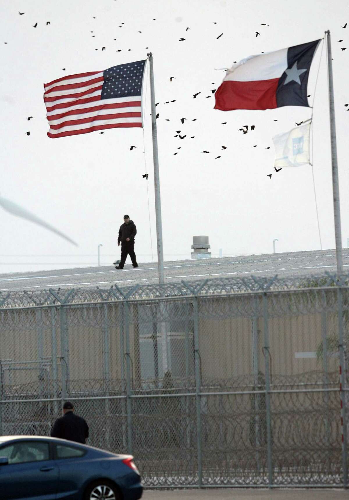 A guard walks on a roof at at the Willacy County Correctional Center in Raymondville. The facility held as many as 2,800 immigrants charged with low-level crimes.