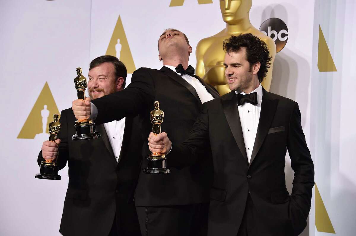 Thomas Curley, left, Ben Wilkins and Craig Mann pose in the press room with the award for best sound mixing for iWhiplashi at the Oscars on Sunday, Feb. 22, 2015, at the Dolby Theatre in Los Angeles. (Photo by Jordan Strauss/Invision/AP) ORG XMIT: MER2015022300262624