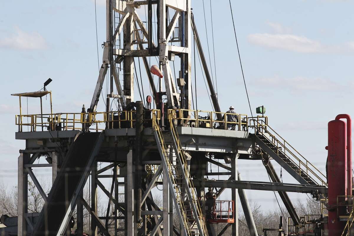 Work continues on a drilling rig off Texas State Highway 72 east of Tilden, Texas, Thursday, February, 19, 2015. A drop in the price of crude oil from has led to lower prices at the pump for consumers. Hovering close to $50 from a high of over $100 per barrel of oil has led to a slow down activity in the Eagle Ford Shale play.