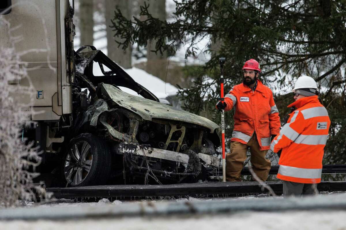 VALHALLA, NY - FEBRUARY 04: Officials inspect a Metro-North train crash with a sport utility vehicle that occured last night on February 4, 2015 in Valhalla, New York. The crash started a fire in the train cars that killed seven people, including the driver of the vehicle.
