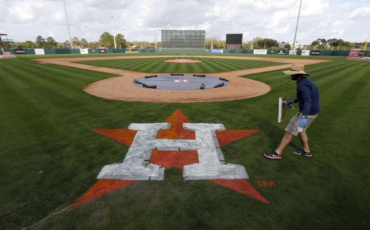 Osceola County groundskeeper Wayne Thompson work on painting the Houston Astros logo on the field at the Osceola County Stadium, Monday, Feb. 23, 2015, in Kissimmee. ( Karen Warren / Houston Chronicle )