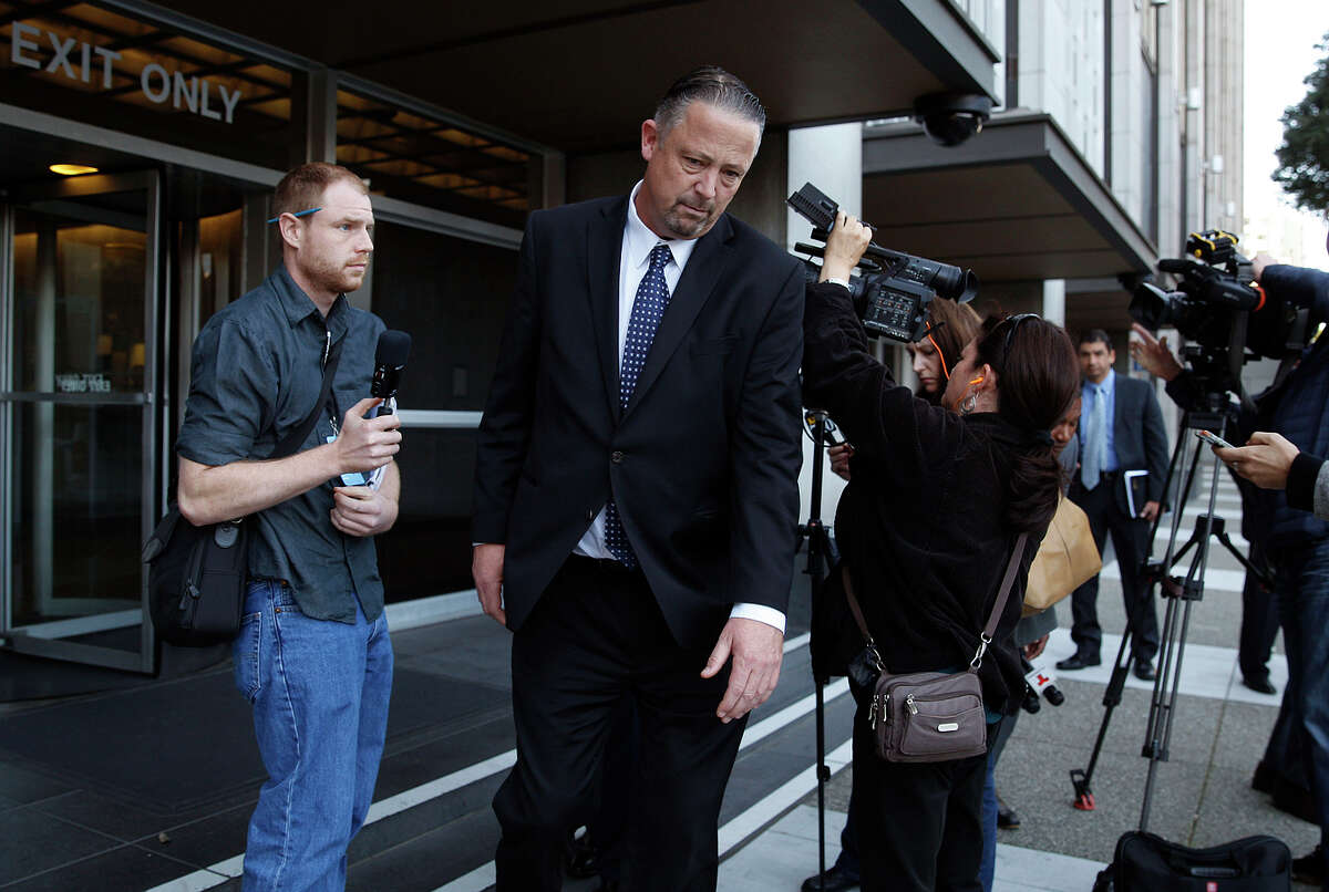 Former San Francisco police Sgt. Ian Furminger (center) leaves after speaking to reporters behind the Phillip Burton Federal Building and United States Courthouse after being found guilty of four felony charges.