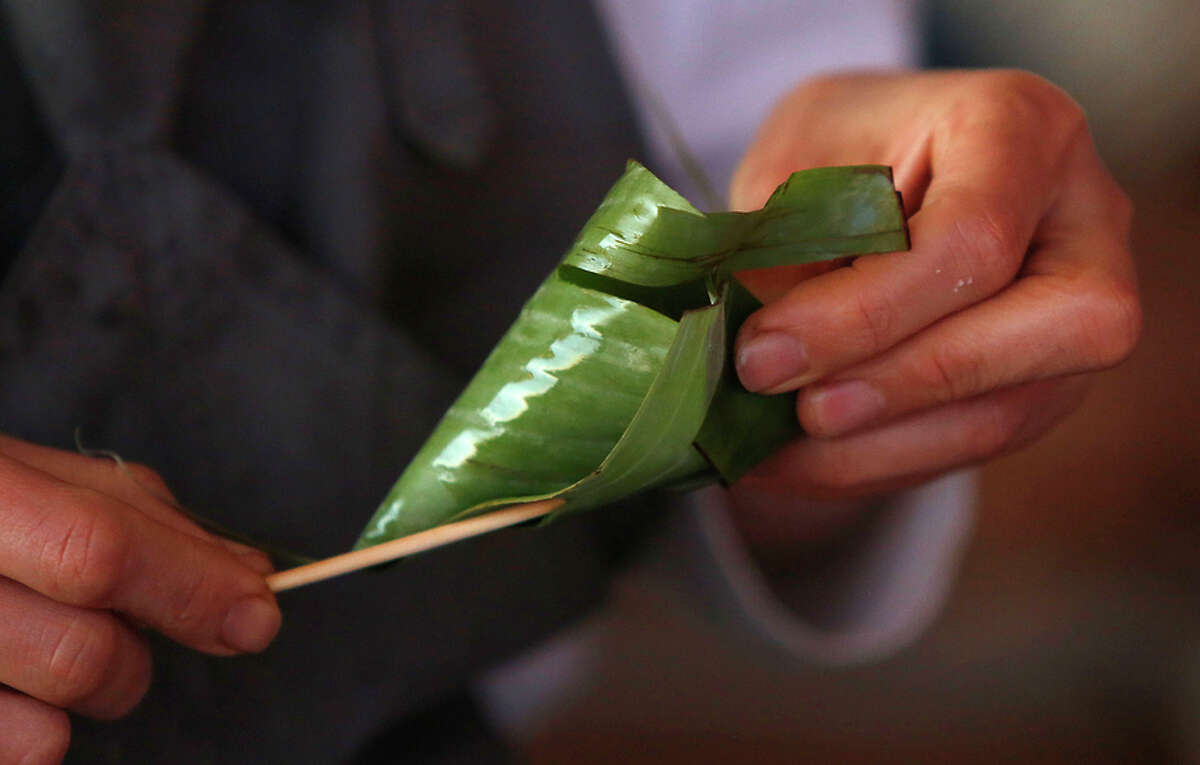 Banana leaves are rolled to carry rice for a wine club event at Scribe winery in Sonoma.