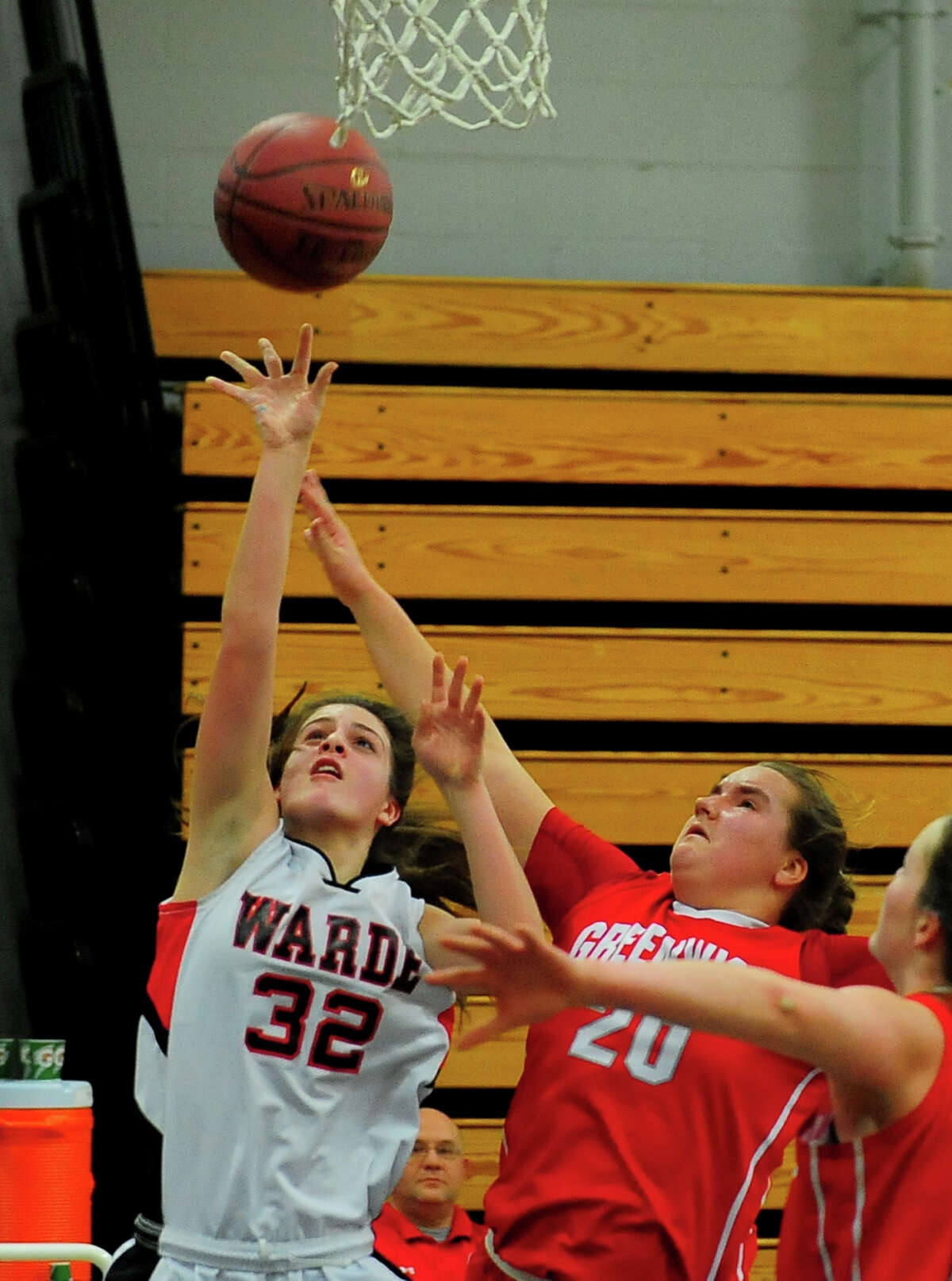 Fairfield Warde's Olivia Parisi sends the ball to the hoop as Greenwich's Abigail Wolf defends, during FCIAC Girls' Basketball Semi-finals action in Fairfield, Conn. on Tuesday Feb. 24, 2015.