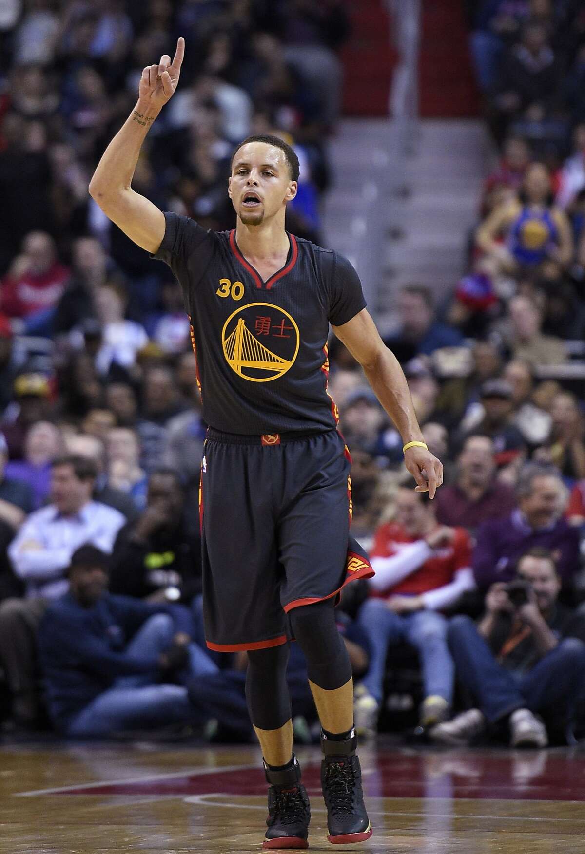 Golden State Warriors guard Stephen Curry (30) gestures after he scored during the first half of an NBA basketball game against the Washington Wizards, Tuesday, Feb. 24, 2015, in Washington. (AP Photo/Nick Wass)