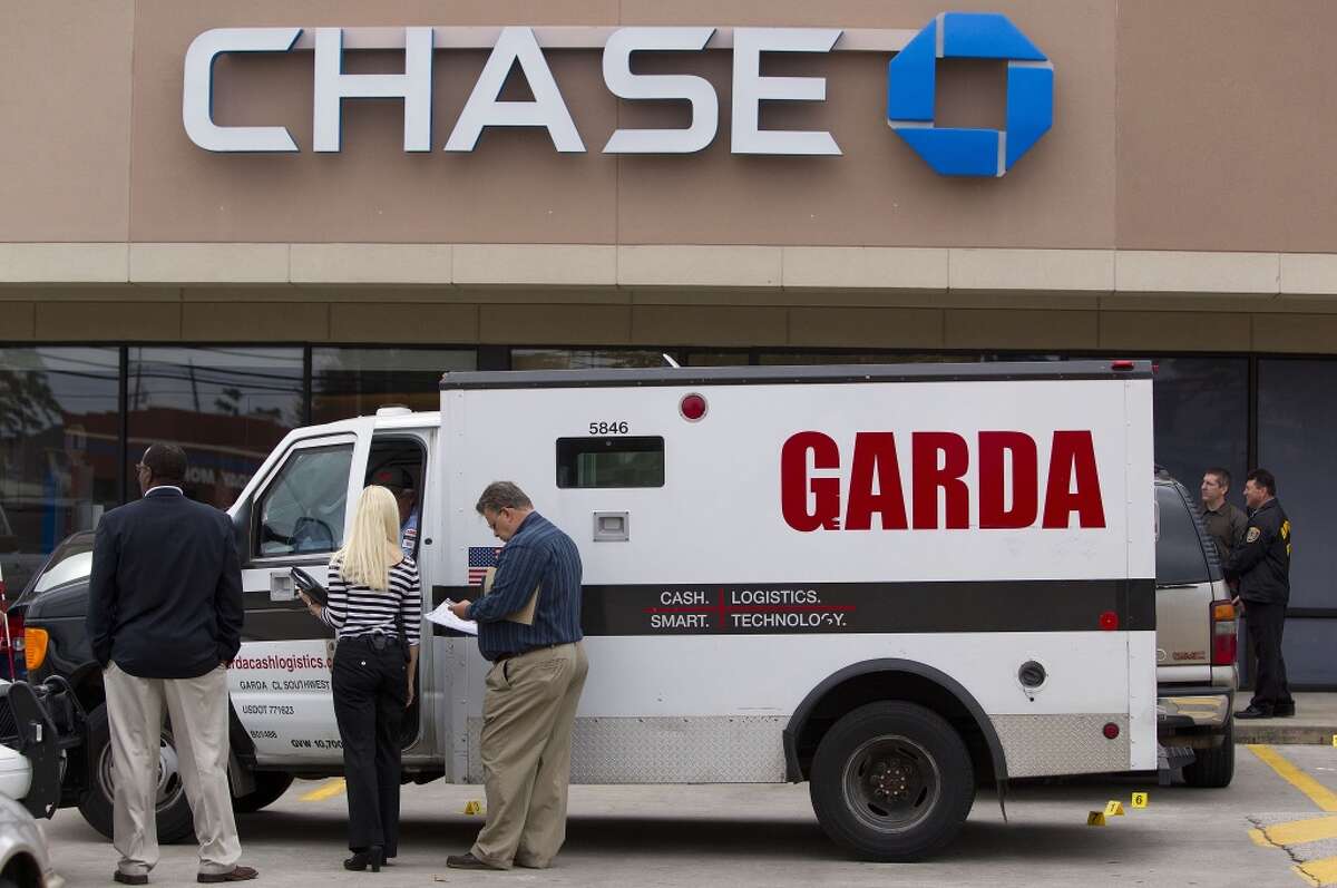 Police investigate an attempted robbery of an armored truck guard outside a Chase bank at the 4700 block of Louetta Road near Kuykendahl Road on Oct. 22, 2013.