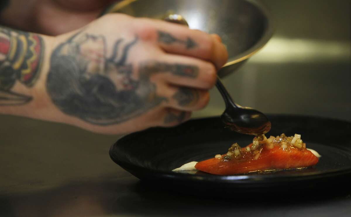 San Francisco chef Brett Cooper puts the finishing touches on a dish at Coi Restaurant in San Francisco, Calif. Monday, February 9, 2015 while a crew from ChefsFeed, an app showcasing chef's favorite restaurants, film a short stop-action movie of his process.