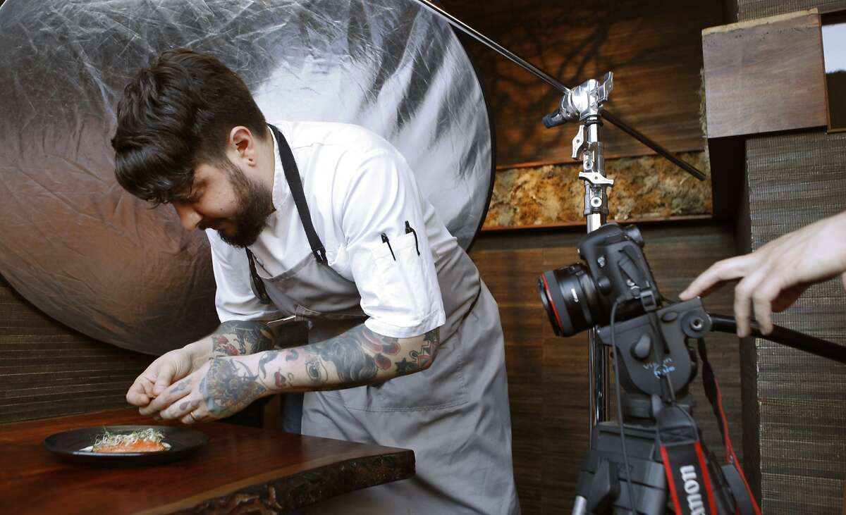 San Francisco chef Brett Cooper puts the finishing touches on a dish at Coi Restaurant in San Francisco, Calif. Monday, February 9, 2015 while a crew from ChefsFeed, an app showcasing chef's favorite restaurants, film a short stop-action movie of his process.