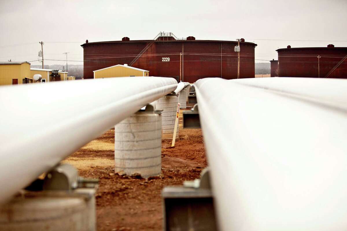 Oil pipelines run near storage units in Cushing, Okla., where tanks are filling up as U.S. crude inventories increase.