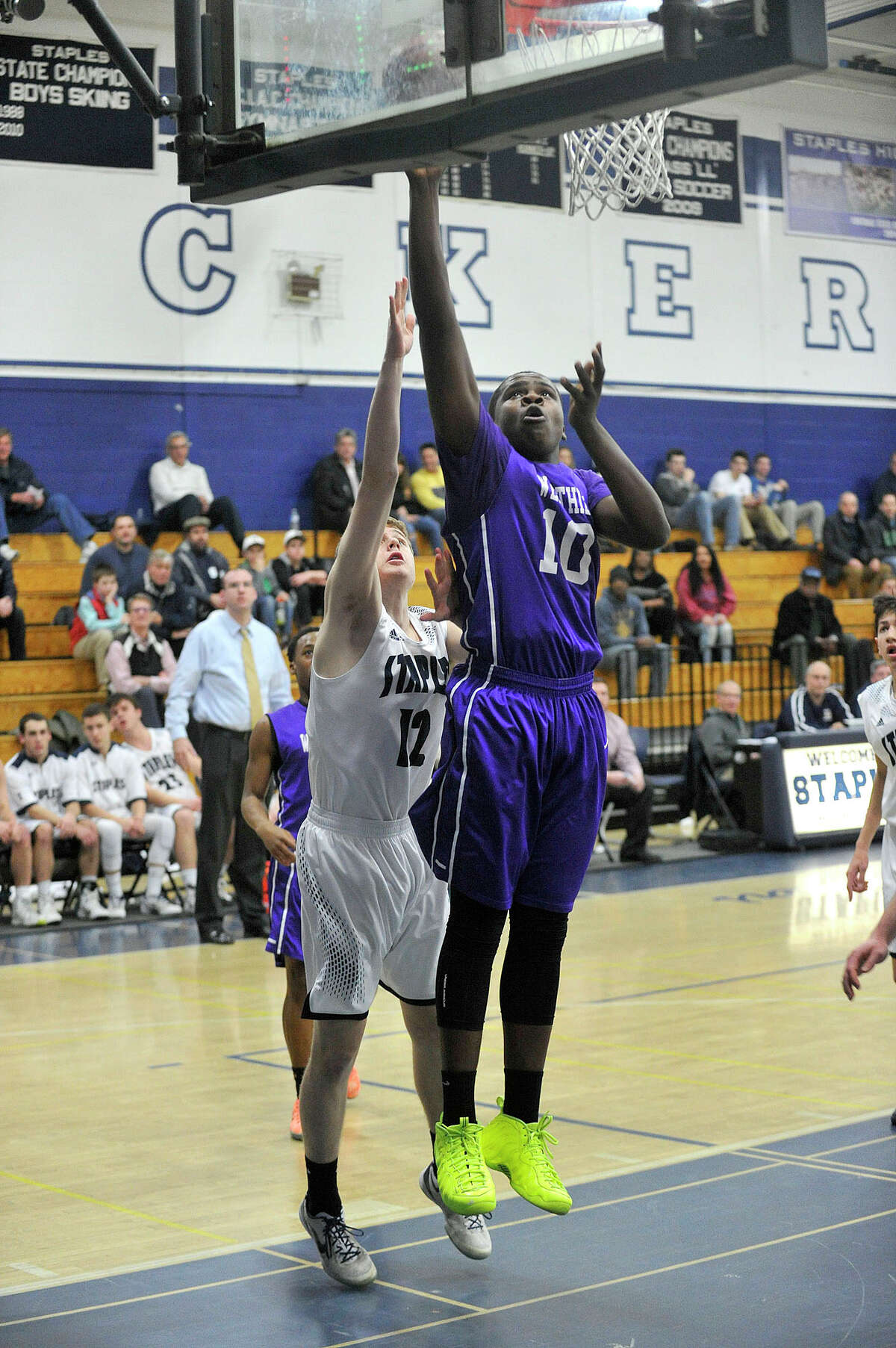 Westhill's Tyrell Alexander puts up a shot while under pressure from Staples' Sean Pritchett during their game at Staples High School in Westport, Conn., on Wednesday, Feb. 25, 2015. Westhill ended their season in FCIAC play undefeated by beating Staples, 64-43.