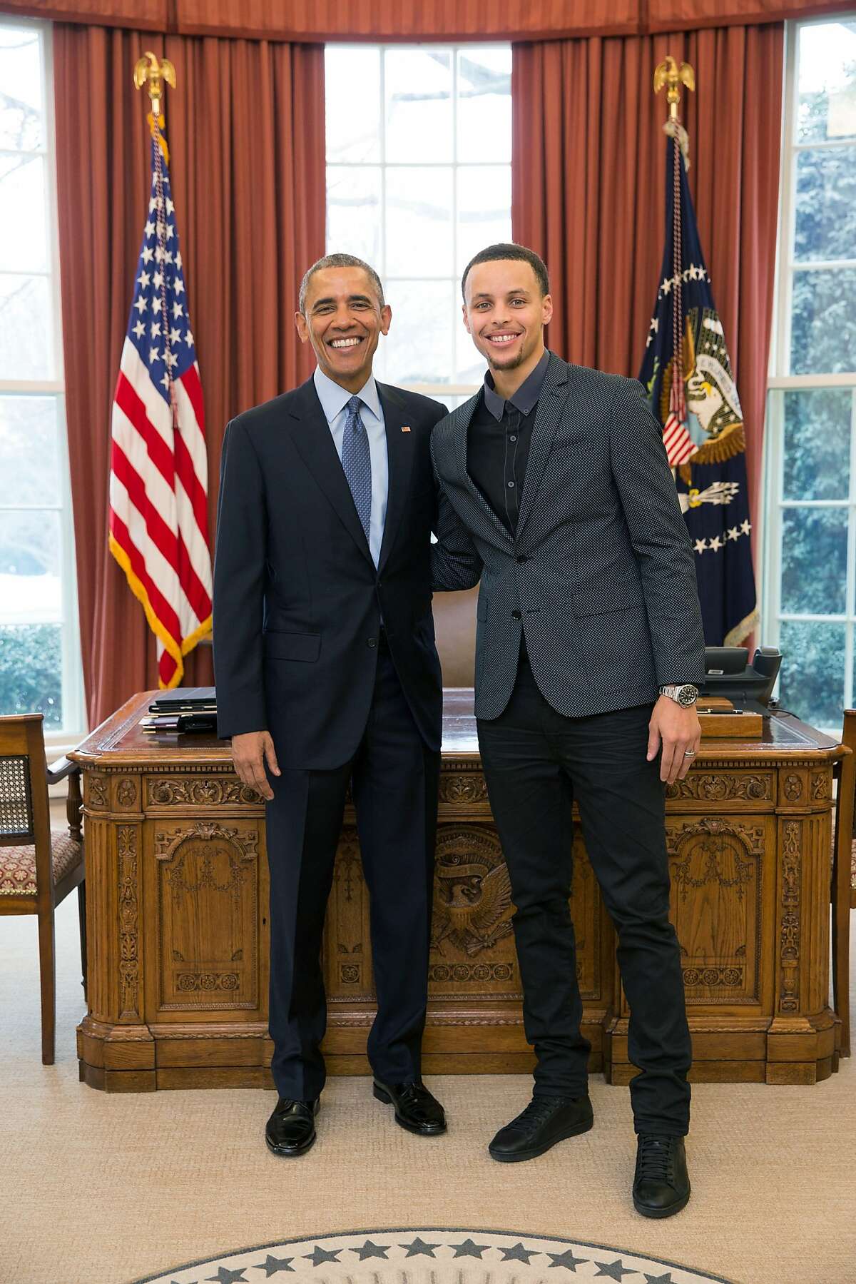 President Barack Obama poses with Warriors guard Stephen Curry in the Oval Office at the White House during Curry's visit on Wednesday.
