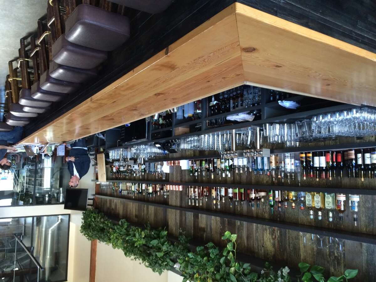 A view of the long wood-topped bar at Sunset Reservoir Brewing Company.