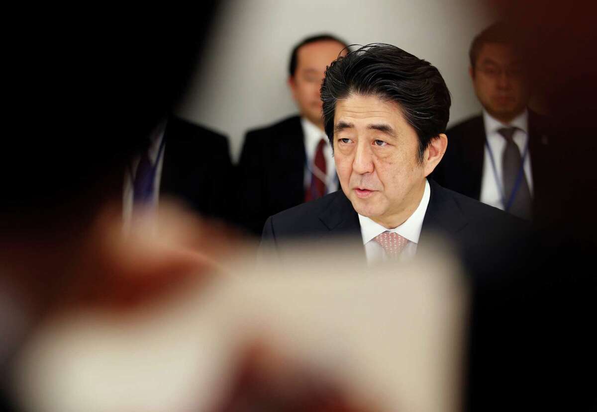 Japanese Prime Minister Shinzo Abe speaks at a meeting with a panel of experts at his official residence in Tokyo, Wednesday, Feb. 25, 2015. The panel of experts appointed by Abe met for the first time Wednesday to discuss what he should say in a statement marking the 70th anniversary of the end of World War II, fueling speculation that he may water down previous government apologies for the country's wartime past. (AP Photo/Shizuo Kambayashi)