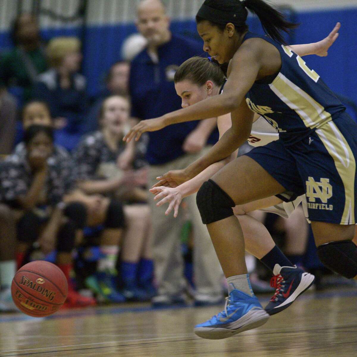 New Fairfield's Emily Farrell (2) and Notre Dame's Gabrielle Joseph (21) chase down a loose ball during the 1st half of the SWC Girls Basketball Championship Game between Notre Dame - Fairfield and New Fairfield high schools, played at Newtown High School, Newtown, Conn, on Thursday night, February 26, 2015.