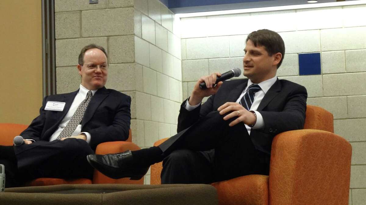 Matt White, chief financial officer of Praxair, addresses students at Western Connecticut State University in Danbury, Conn., as Union Savings Bank CFO Paul Bruce looks on. WestConn's Ancell School of Business held its inaugural CFO Forum on February 26, 2015.