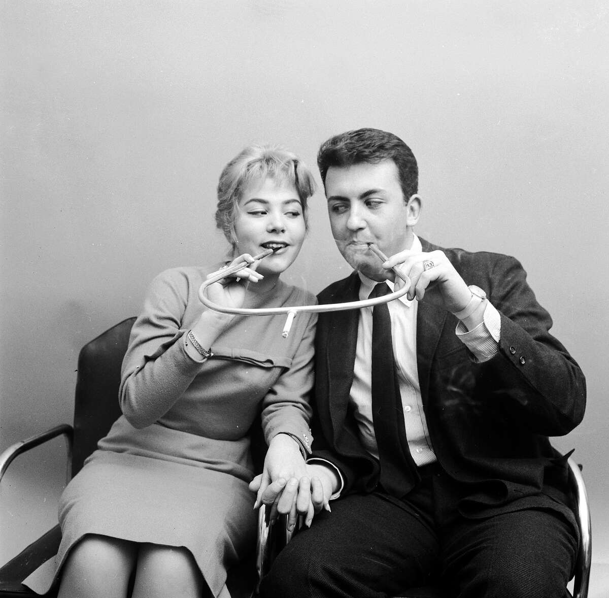 Cigarette holder made for two, 1955 Half the nicotine, twice the intimacy. But come on.