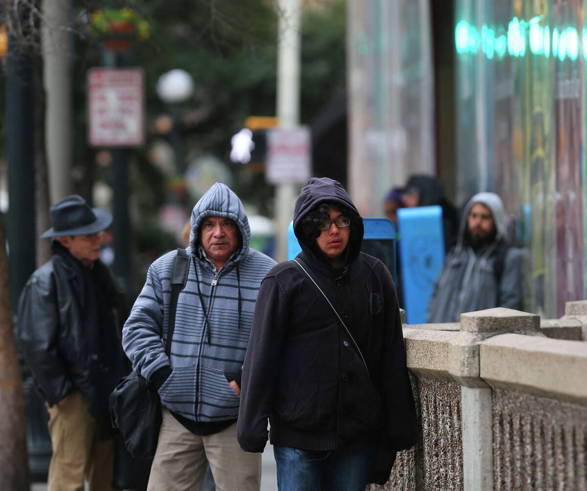Pedestrians brave the cold temperatures Friday February 27, 2015 on St. Marys street in downtown San Antonio. Temperatures in the area have been in the 30 degree range.