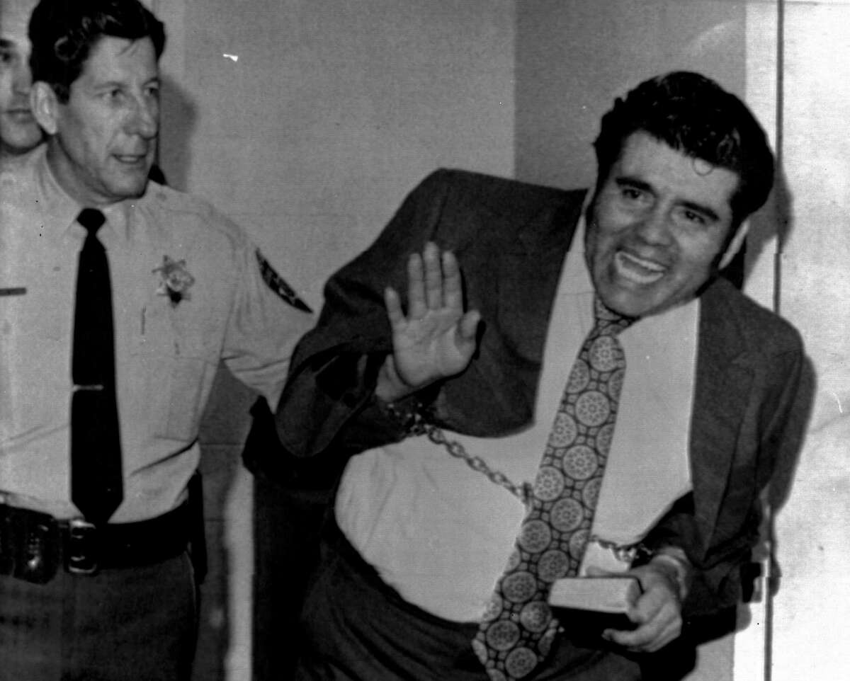 Convicted mass slayer Juan Corona waves as he leaves the Solano County Hall of Justice in Fairfield on Feb. 5, 1973. Corona was convicted of the mass slayings of 25 itinerant farm workers and burying their bodies in orchard graves north of Yuba City.