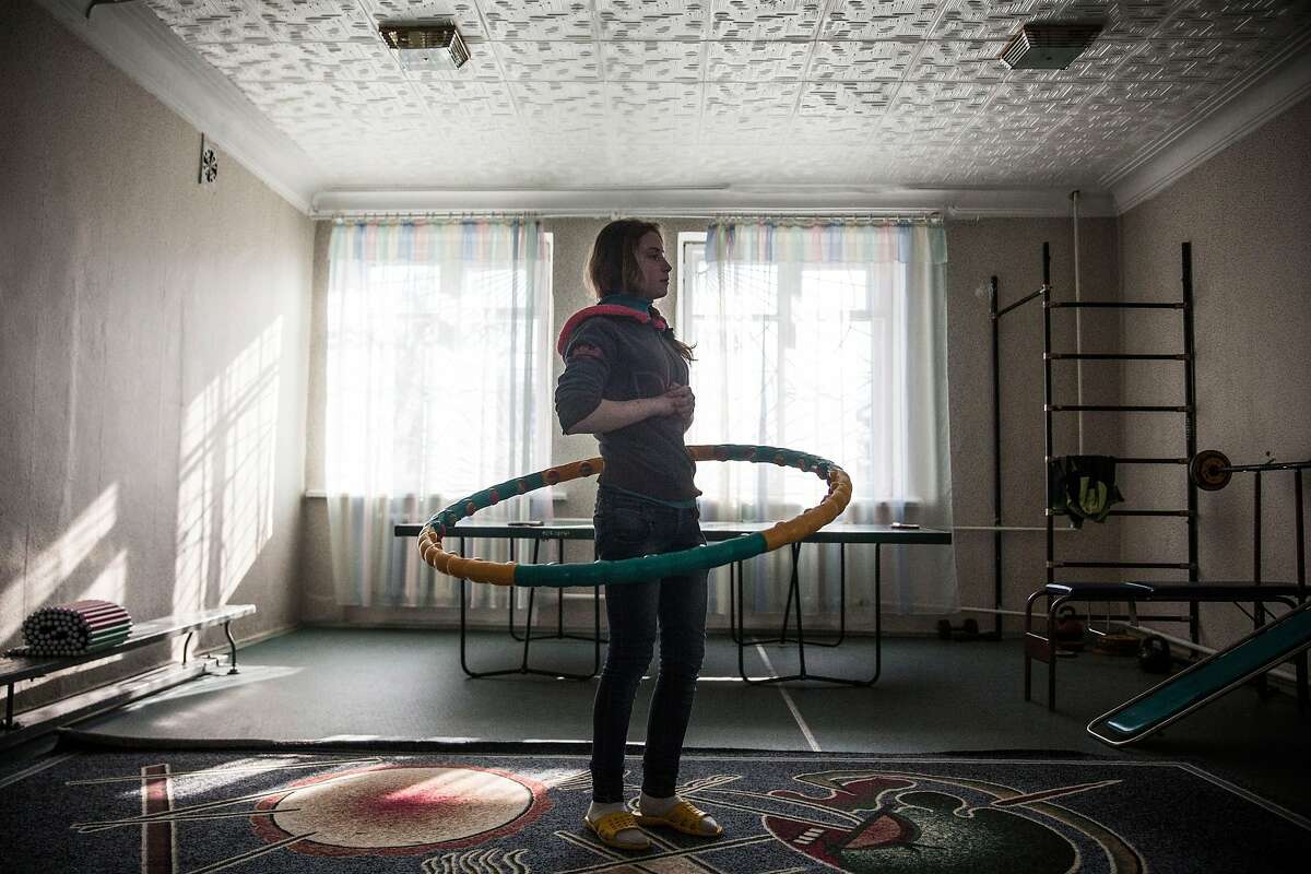 A girl practices with the hoola-hoop during gym class at Torez Special Secondary boarding school #43 on February 27, 2015 in Torez, Ukraine. The school acts as both a school for local children and an orphanage for children who no longer have a place to live. The school receives assistant from pro-Russian rebels. Eastern Ukraine has seen sporadic fighting between the Ukrainian Army and pro-Russian rebels for the past year, killing over 5,000 people. (Photo by Andrew Burton/Getty Images) 