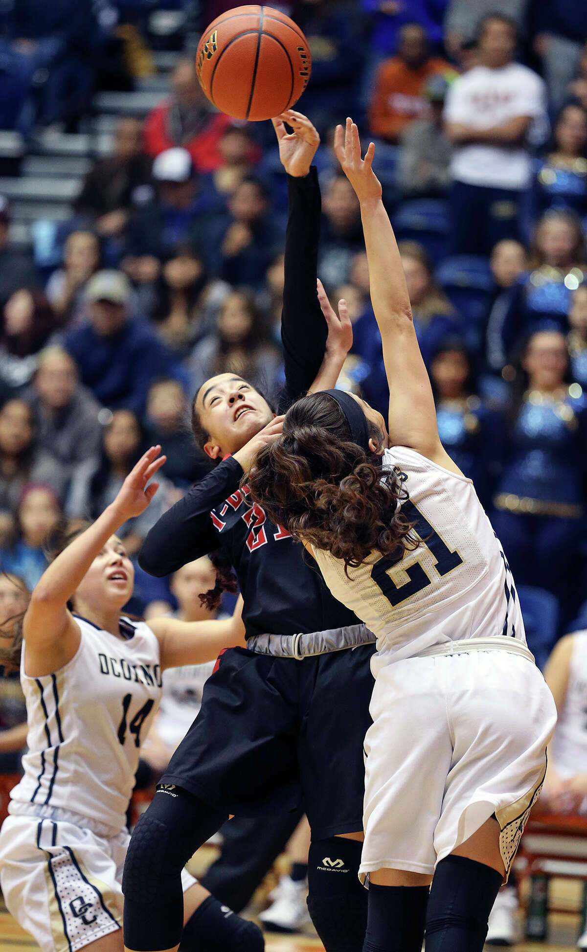 Thunderbird guard Toni Cuellar is fouled on a shot by Brianna Kallead as Wagner beats O'Connor 55-40 to win the Region IV-6A girls basketball final at the UTSA Convocation Center on February 28, 2015.