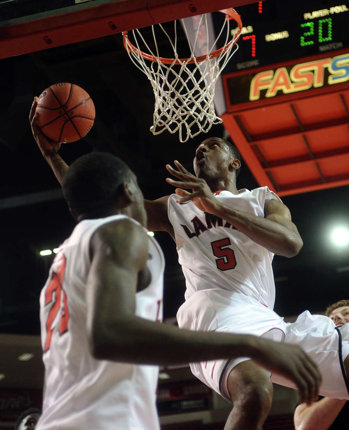 Lamar's Tyran de Lattibeaudiere, No. 5, hooks a shot underneath the basket during Saturday's game against Incarnate Word. The Lamar Cardinals hosted the Incarnate Word Cardinals at the Montagne Center on Saturday night. Photo taken Saturday 2/28/15 Jake Daniels/The Enterprise