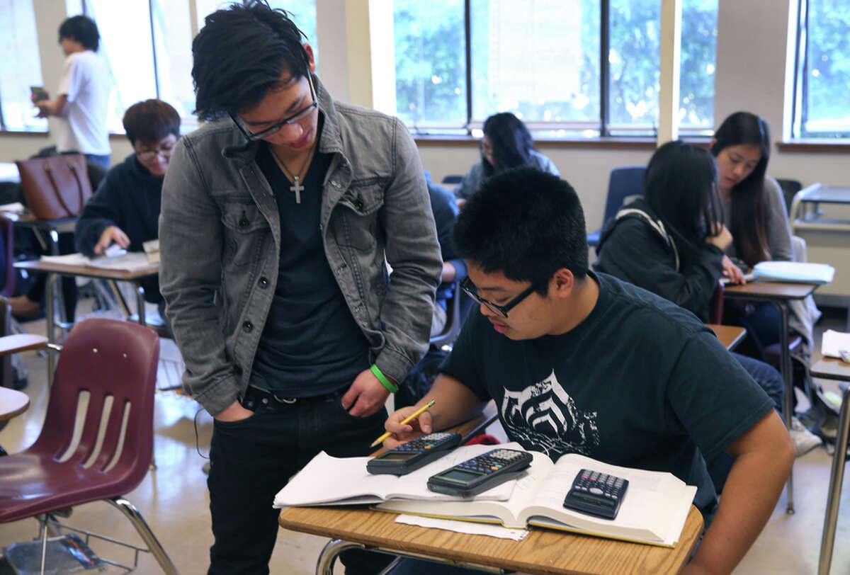 Jared Luo (left) and Huy Do work together on a problem in an Advanced Placement calculus class at Burton High School.