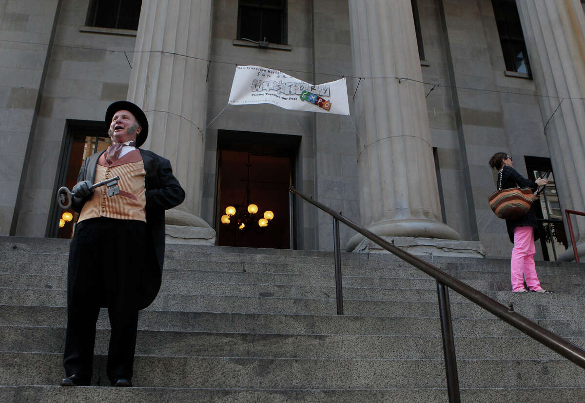 Allan Shwartz, portraying Mayor Sutro, welcomes people to an event at the Old Mint last month. The city has ousted the group trying to turn it into a museum.