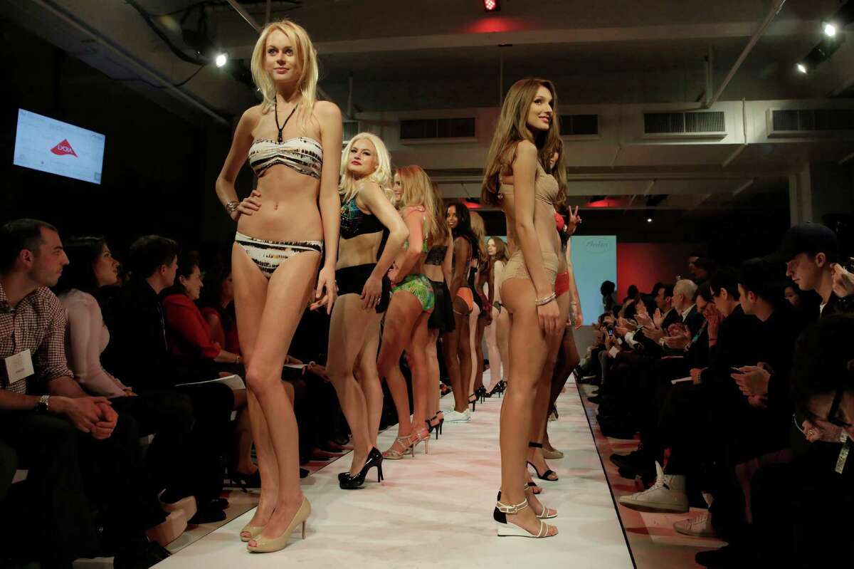 Models pose on the runway during the fianle of the 2015 CURVExpo and Invista sleepwear, loungewear and swim collections, during the 2nd annual Lingerie Fashion Night, "Romancing the Runway," in New York, Monday, Feb. 23, 2015.