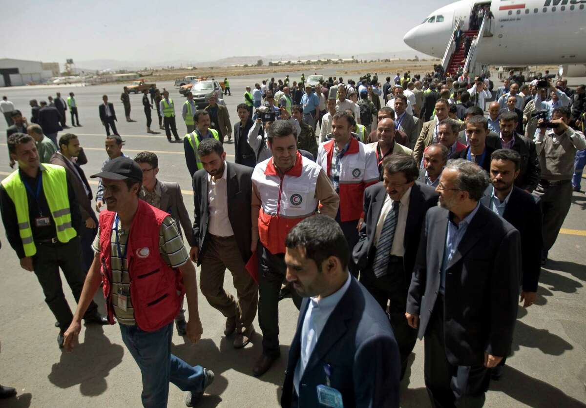 Aid workers from the Iranian Red Crescent and other passengers arrive to the international airport of Sanaa, Yemen, Sunday, March 01, 2015. The first direct flight from Iran to the rebel-held Yemeni capital arrived Sunday as the country's Shiite rebels formalize ties with the regional Shiite powerhouse. (AP Photo/Hani Mohammed)