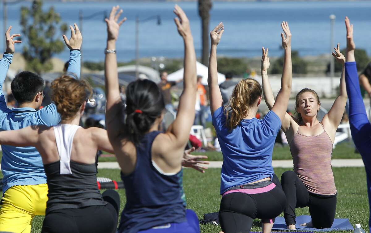 Leila Burrows of The Pad yoga studio in San Francisco instructs a yoga and pilates class during Off The Grid's Picnic at the Presidio event at the Presidio Main Post lawn in San Francisco, Calif. Sunday, March 1, 2015.