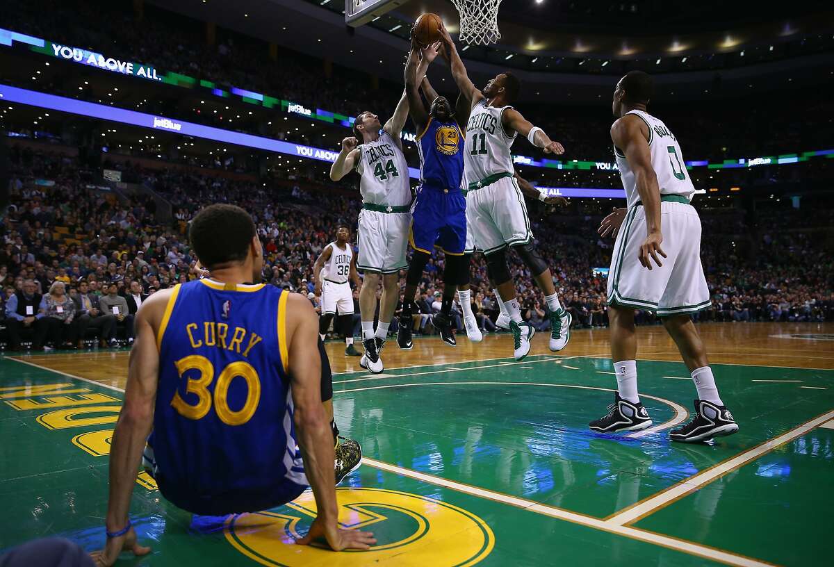 BOSTON, MA - MARCH 01: Draymond Green #23 of the Golden State Warriors reaches for a rebound between Tyler Zeller #44 and Evan Turner #11 of the Boston Celtics during the second quarter at TD Garden on March 1, 2015 in Boston, Massachusetts. NOTE TO USER: User expressly acknowledges and agrees that, by downloading and or using this photograph, User is consenting to the terms and conditions of the Getty Images License Agreement (Photo by Maddie Meyer/Getty Images)
