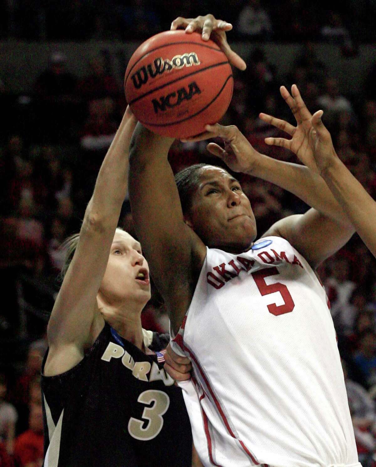 Purdue’s Natasha Bogdanova (left) gets a hand on the ball as Oklahoma’s Ashley Paris tries to make a shot in the first half an NCAA tournament regional championship game in Oklahoma City, on March 31, 2009.