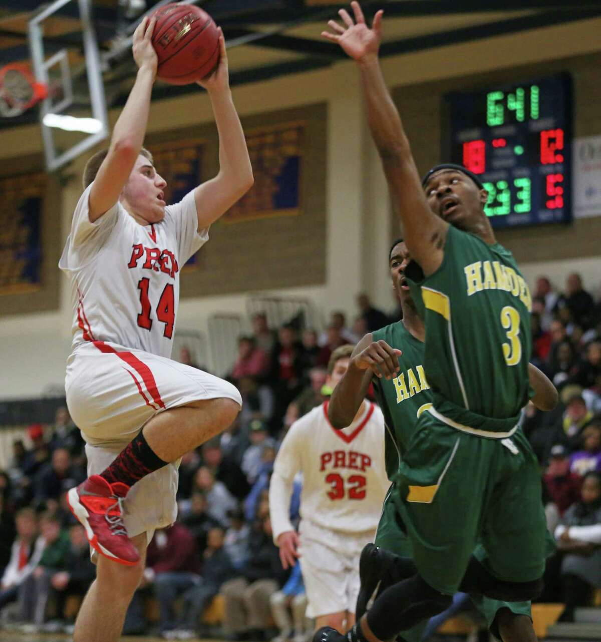 Fairfield Prep's #14 Richard Kelly shoots to the basket during Monday evening SCC semifinals against Hamden High School. Fairfield Prep would win 68-51.