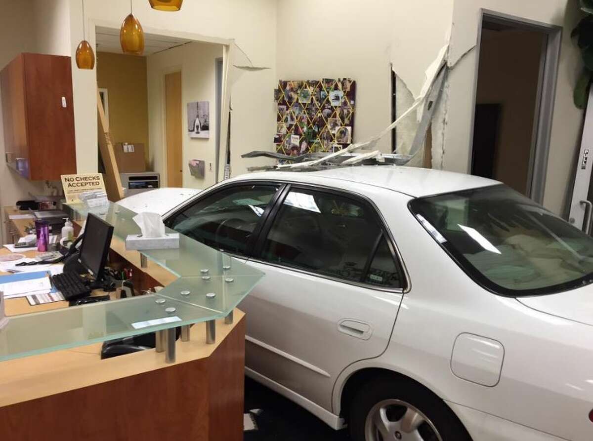 I'M SORRY, DO YOU HAVE AN APPOINTMENT? A Honda sedan sits next to the front desk of the United Emergency Animal Clinic in Campbell, Calif., after smashing through the front doors. No one was injured. Police said speed was the likely cause of the accident.