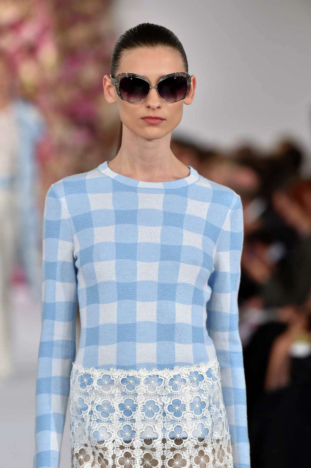 Gingham is predicted to be the print of the spring season in dresses, skirts, tops, jackets and long coats as seen in this look from Oscar de la Renta.