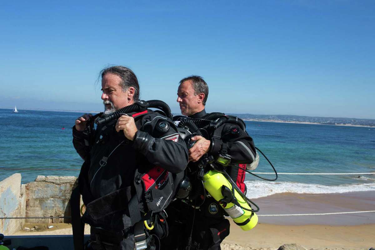 Scott Cooper (right), a dive instructor and general manager at BreakWater Scuba in Monterey, teaches diver Andy Wallace of Davis in a new underwater breathing apparatus called a rebreather.